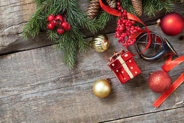 Holiday Xmas concept. Christmas card red balls, fir tree and decor on a rustic wooden background. Top view flat lay. Copy space.