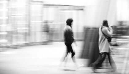 pedestrians walking city black and white motion blur