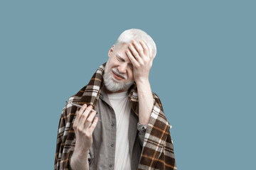 Fever and flu. Sick albino guy touching forehead holding thermometer, having influenza symptoms