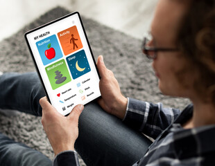Young man using medical app on digital tablet