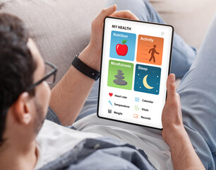 Young man enjoying brand new health app on tablet
