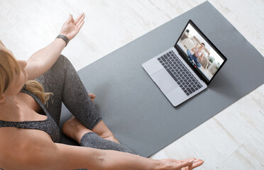 Yoga Lessons Online. Young Woman Practicing Meditation Via Video Call With Coach