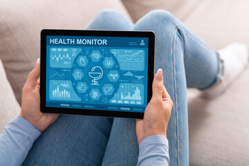 Lady using health monitor mobile application on digital tablet