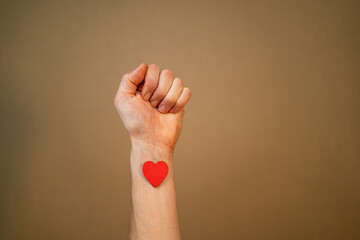 man haveing red heart on his arm