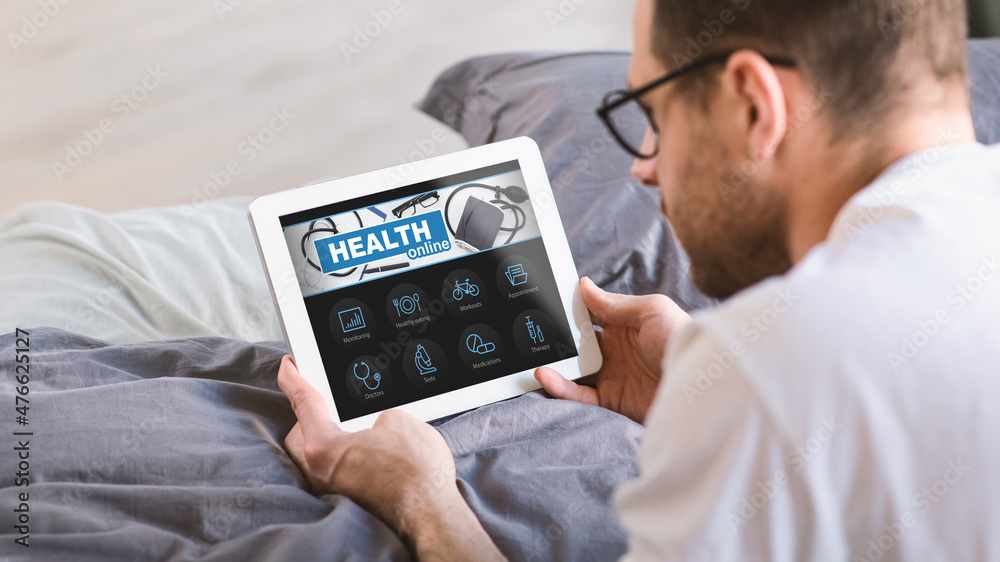 Aufkleber Man Using Digital Tablet While Lying In Bed