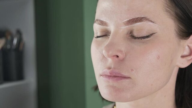 eyebrow painting styling, correction, coloring and lamination procedure in a beauty salon, eye brow care treatment