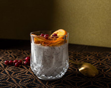 Sweet stracciatella ice cream with slices of orange and berries