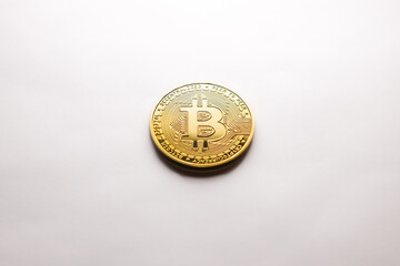 A single Bitcoin gold coin on a white background, as a product shooting