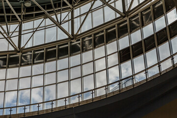Big windows in factory building interior, blue sky outdoors