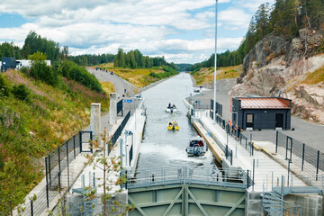 Kouvola, Finland - 5 August 2021: Kimola Canal between lakes. Gateway is open for boats going though. - obrazy, fototapety, plakaty