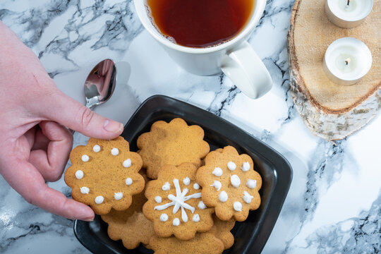 Overhead shot of a plate with homemade traditional Finnish gingerbread cookies and a teacup.