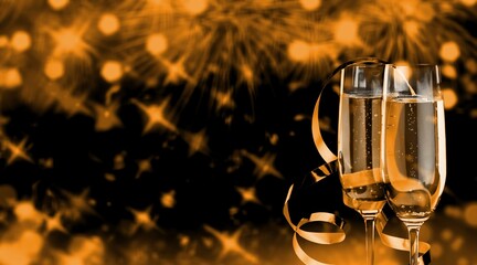 Two champagne glasses with and gold glitter splash bokeh on dark background. Luxury restaurant dinner celebration.