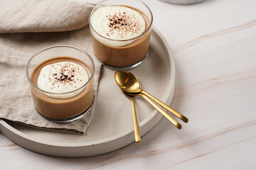 Italian chocolate and coffee mousse dessert semifreddo - half-frozen ice cream with whipped cream and cocoa powder in small glasses
