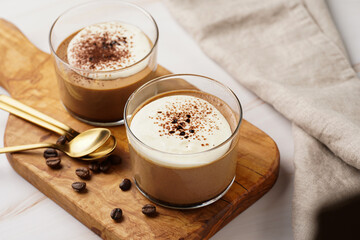 Italian chocolate and coffee mousse dessert semifreddo - half-frozen ice cream with whipped cream and cocoa powder in small glasses