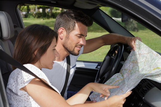 couple looking at a map in the car