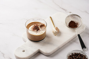 Italian chocolate and coffee mousse dessert semifreddo - half-frozen ice cream with whipped cream and cocoa powder in small glasses
