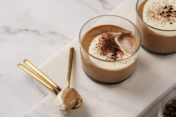 Italian chocolate and coffee mousse dessert semifreddo - half-frozen ice cream with whipped cream and cocoa powder in small glasses