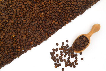 Coffee beans in a wooden scoop isolated on a white background. Roasted coffee beans isolated. A wooden scoop with coffee.