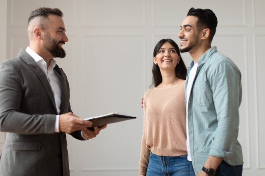 Couple Buying New Apartment Talking With House Agent