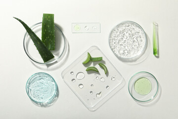 Flat lay composition with cosmetic gel, laboratory glassware and aloe on white background - obrazy, fototapety, plakaty