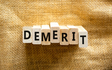 Demerit symbol. The concept word Demerit on wooden blocks. Beautiful canvas background, copy space. Business and demerit concept.