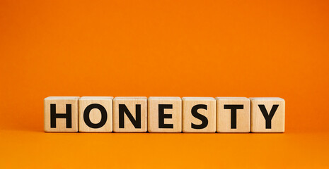 Honesty symbol. The concept word Honesty on wooden cubes. Beautiful orange table, orange background, copy space. Business and honesty concept.