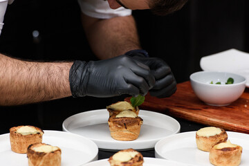 Typical Portuguese custard pies Pastel de Nata or Pastel de Belem. traditional portuguese pastry. On a black tablecloth