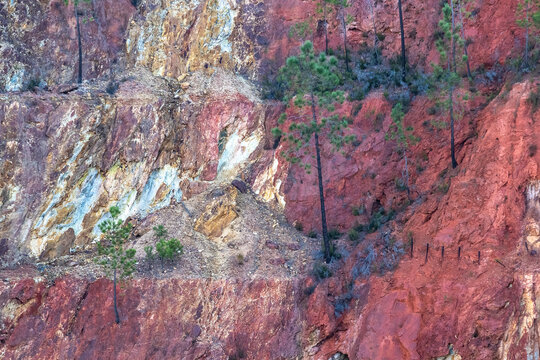 Panorama of Pe&ntilde;a del Hierro open mine pit. Deep excavation of pyrite and extraction of minerals of copper and gold in municipality of Nerva, Huelva, Andalusia, Spain