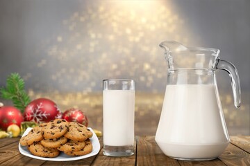 Fresh traditional christmas milk with cookies on Christmas lights background,