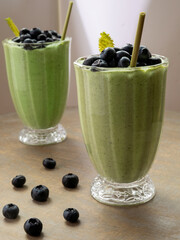 Fototapeta na wymiar Green smoothie drink with fresh blueberry fruit. Detox diet.