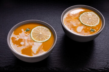 Sweet potato soup cream on black slate. Creamy soup.