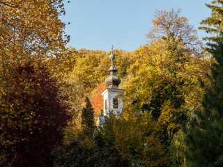 Chapel surrounded by golden yellow forest