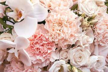 Tender light pink flowers bouquet closeup. Roses and orchids wallpaper. Beautiful background for a Birthday, International Female Day, or Saint Valentine. The festive backdrop for a postcard design