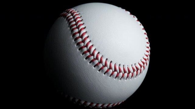 Close up of rotating baseball with black background.