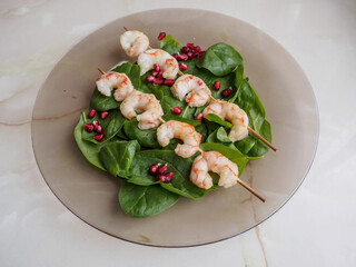 Shrimp served with green leaves