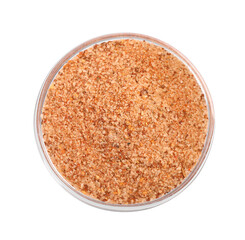 Pink salt with spices in glass bowl isolated on white, top view