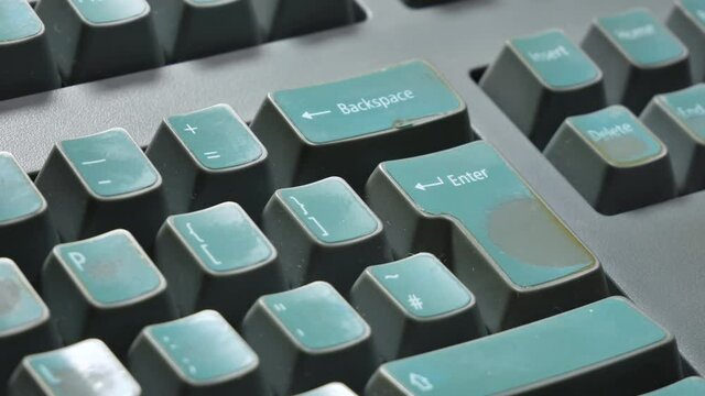 Man forcefully hitting the enter key hard, old computer, retro desktop PC keyboard object detail, finger extreme closeup Confirmation, acceptance, accepting or sending a message abstract concept