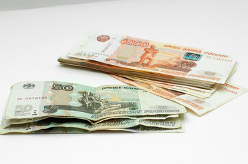 Obraz na płótnie Canvas Russian money, 50 rubles and 5000 rubles. Poverty, inflation, saving money.