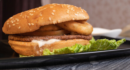 hamburger on a black plate