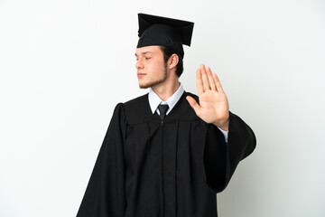 Young university Russian graduate isolated on white background making stop gesture and disappointed