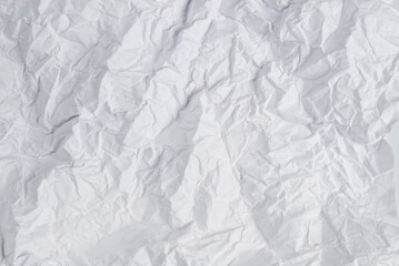 Crumpled white paper background.