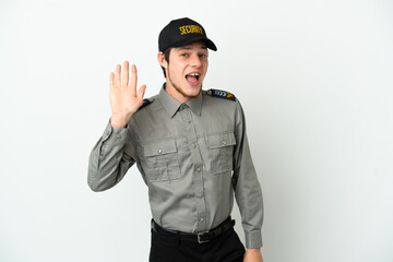 Fototapeta premium Young Russian security man isolated on white background saluting with hand with happy expression