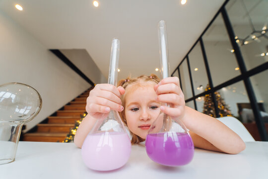 Little girl making chemical experiments at home