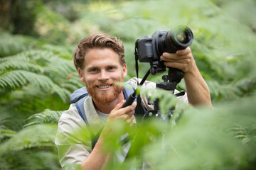 Fototapeta premium man filming holding camera stabilizer