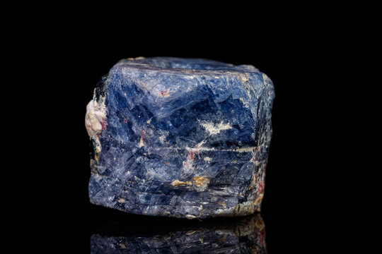 macro mineral stone sapphire on a black background - a blue sapphire stone on a black background