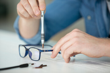 optician repairing and fixing eye glasses