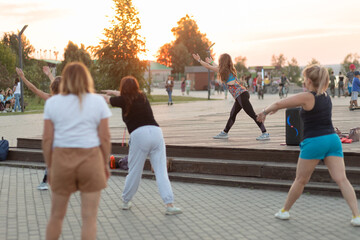 Group of girls doing evening gymnastics outdoor