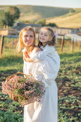 Naklejka premium Mother hugs daughter. Happy family outdoors