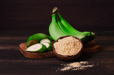 Green banana flour, on a wooden table, healthy food, selective focus, rustic style, horizontal, no people, © Gala_Didebashvili