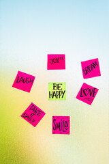 Notes with emotional and motivational words taped to the office window